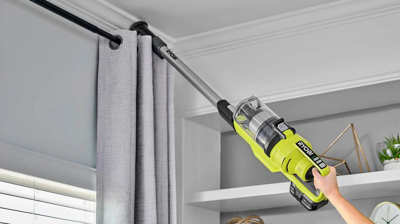 Ryobi 18V One+ Stick Vacuum cleaning a ceiling