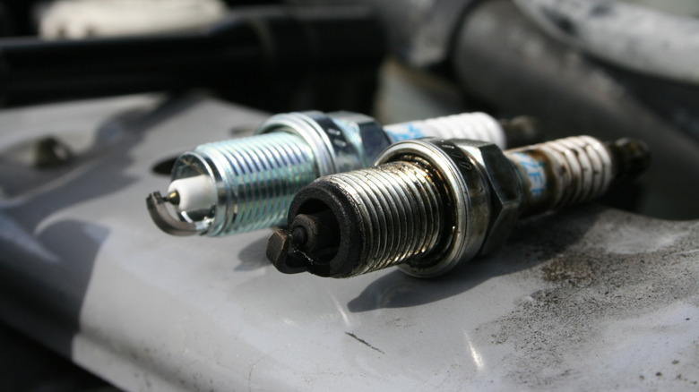 Two spark plugs, one new, one burnt