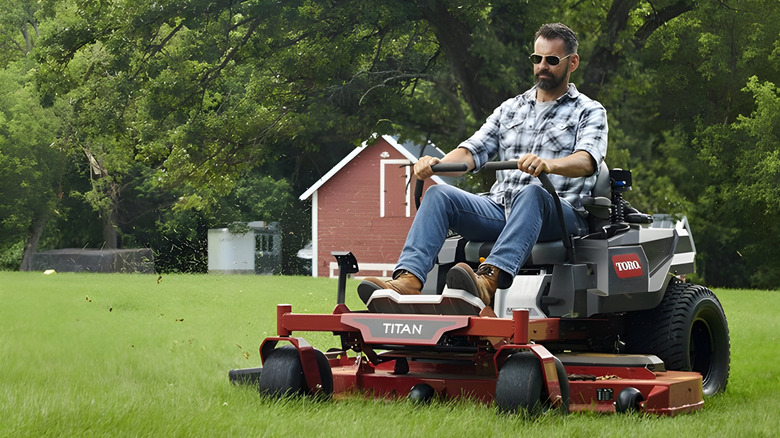 Man using a Toro riding lawn mower