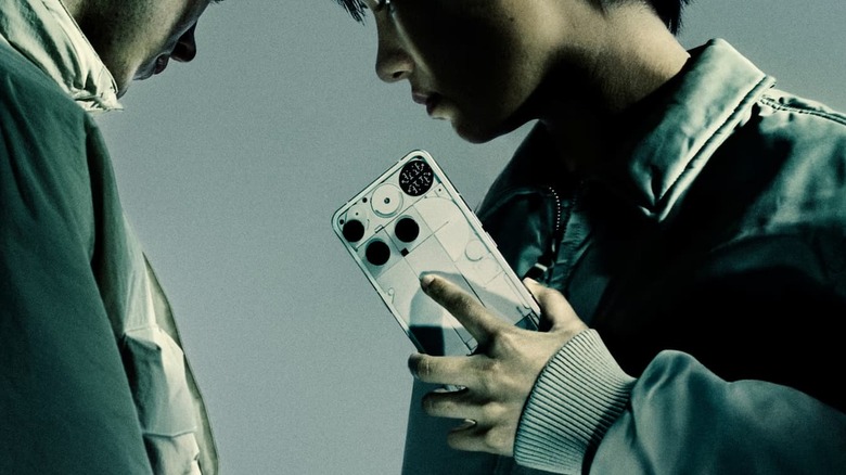 Closeup of a Nothing Phone 3 held by a person, facing another person