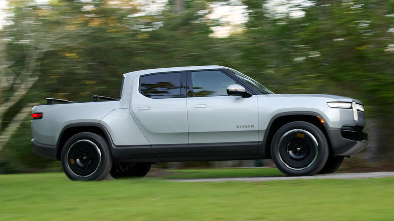 Rivian R1T driving on country road