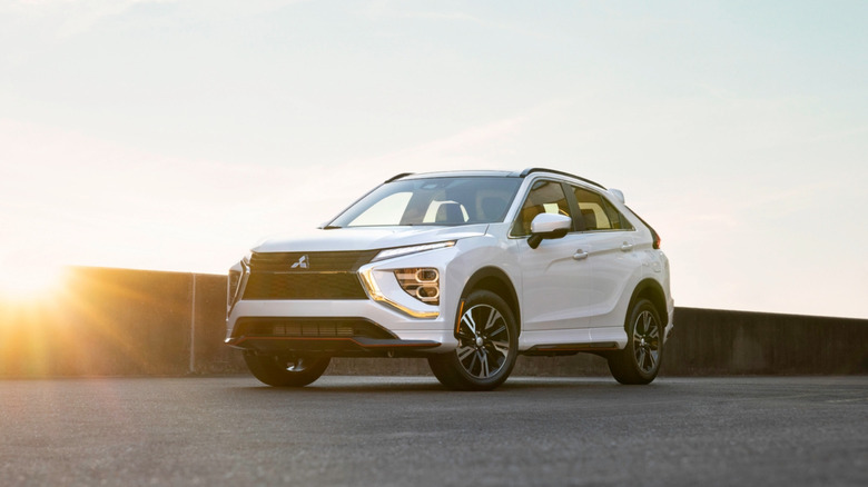 White 2025 Mitsubishi Eclipse Cross parked with the sun behind it