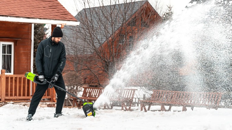 Person using a Greenworks Pro 80V 12-inch Cordless Snow Shovel