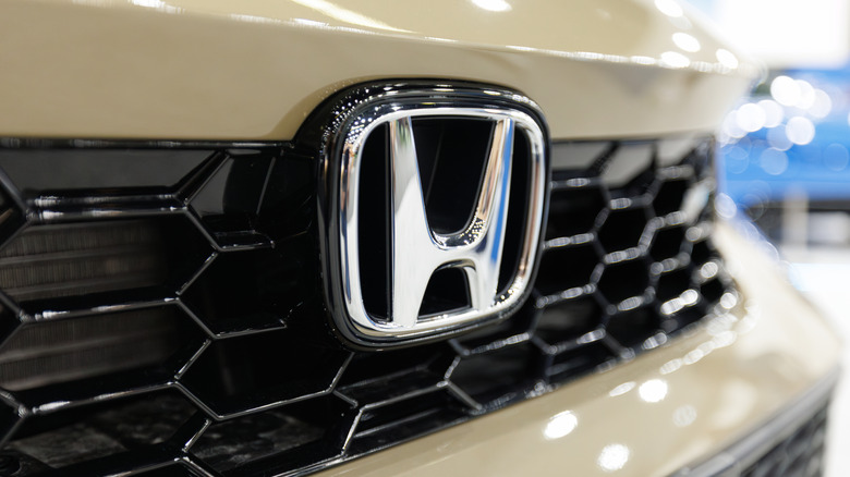 Close-up of Honda logo on a vehicle grille