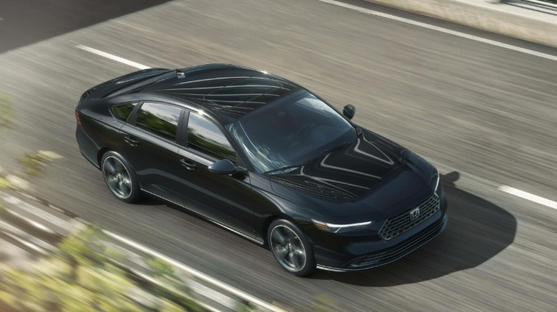 Overhead view of a black Honda Accord Hybrid driving on a road