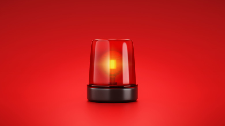 Red emergency siren with a red background
