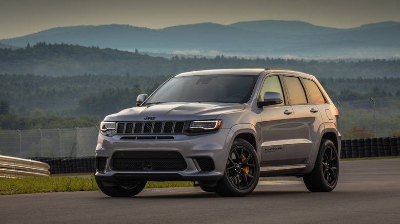 Jeep Grand Cherokee Trackhawk parked on racetrack, front-left three-quarter view
