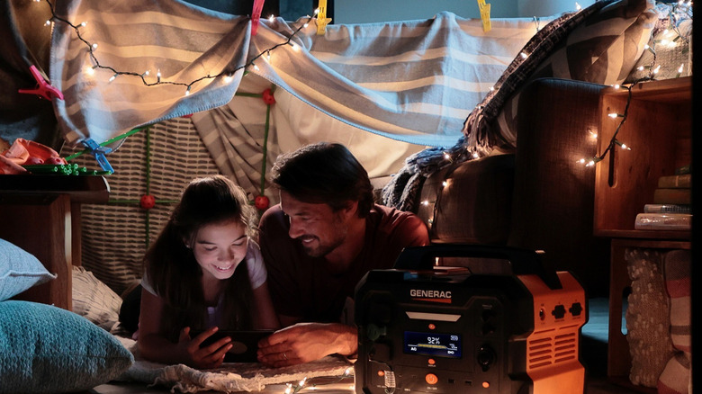 Father and daughter inside bedroom using Generac portable generator