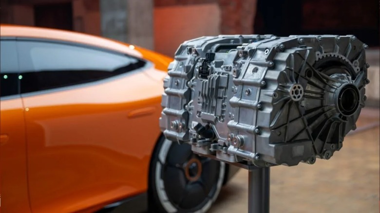 YASA axial flux motor on a stand in front of AMG GT XX