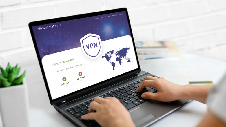 Internet user connecting to VPN on laptop