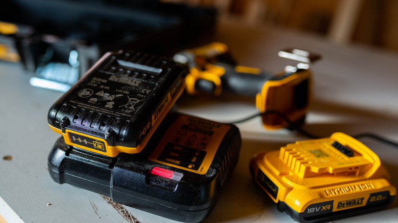 DeWalt batteries and charger on a workbench