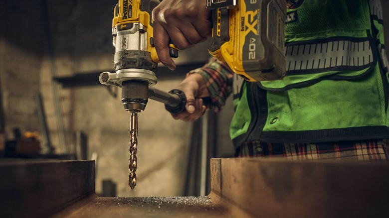 A person drilling into steel using a DeWalt Cobalt Alloy drill bit