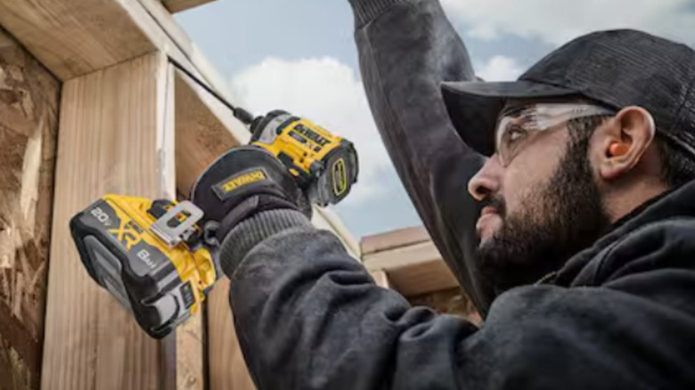 A worker using the DeWalt Impact Driver