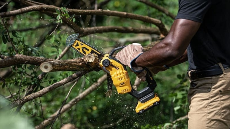 20V Max 8-inch Cordless Pruning Chainsaw in use