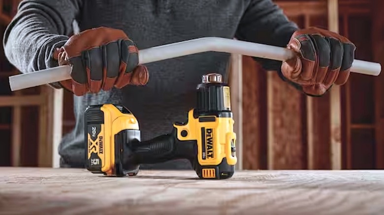 Person using DeWalt Heat Gun to bend metal