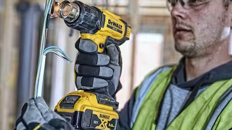 Person using DeWalt Heat Gun on wires