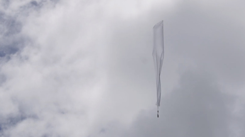 A Windborne weather balloon in the air