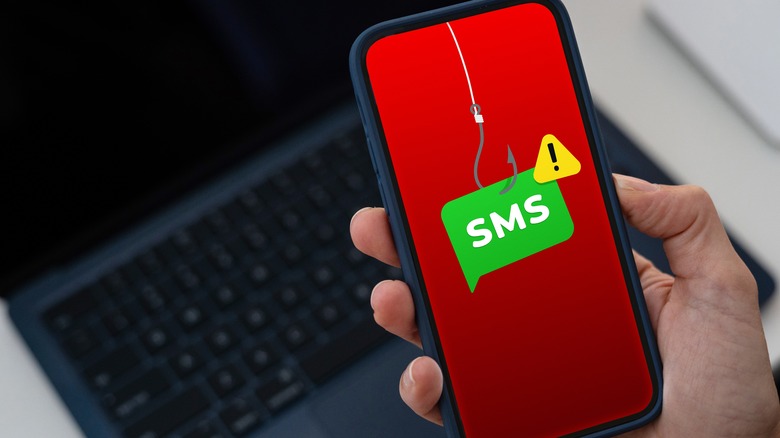 Smartphone showing SMS bubble on fish hook with warning sign