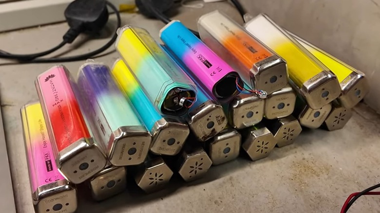 A stack of disposable vapes on a table