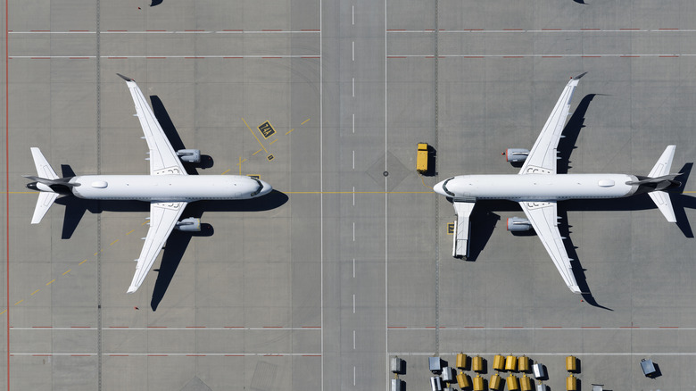 Airplanes parked at airport in front of each other