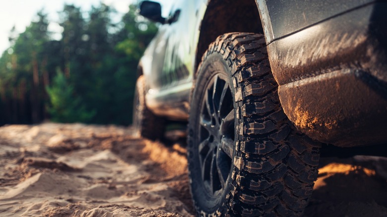A vehicle with all-terrain tires driving off-road
