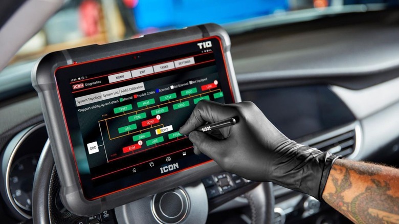 A person using a professional (expensive) icon T10 code reader