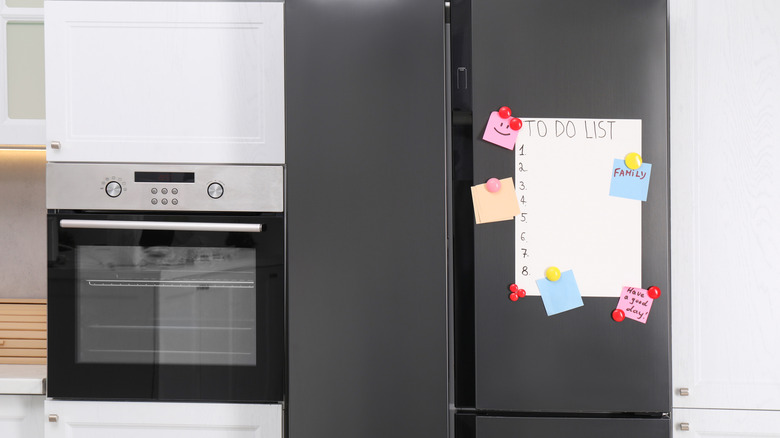 Close up of a refrigerator and oven in a kitchen.