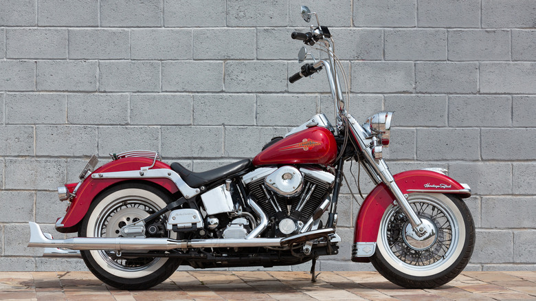 A Harley-Davidson motorcycle against a brick wall.