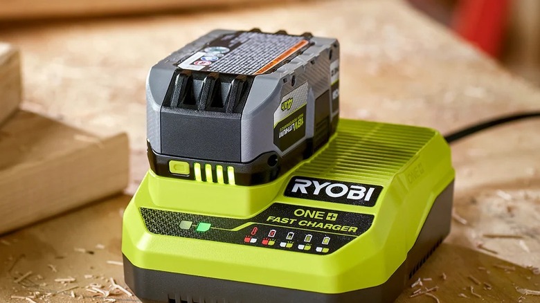 Ryobi Fast Charger on wooden table charging 4Ah battery
