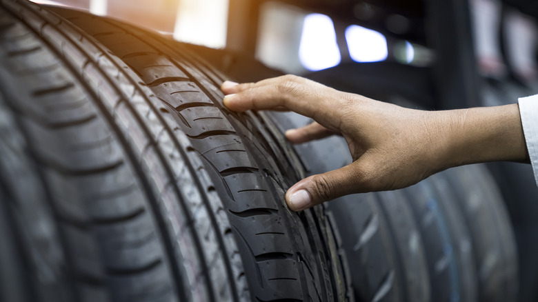 Person touching an automobile tire