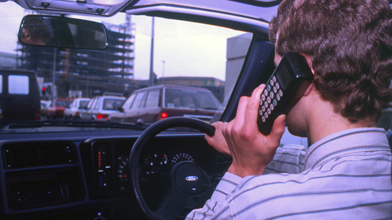 Person driving and using car phone