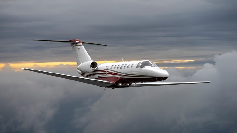 Private jet flying above storm clouds