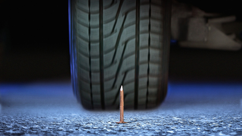 Close-up of a tire heading for an upturned nail