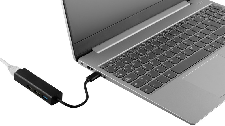 A USB to Ethernet adapter connected to a laptop