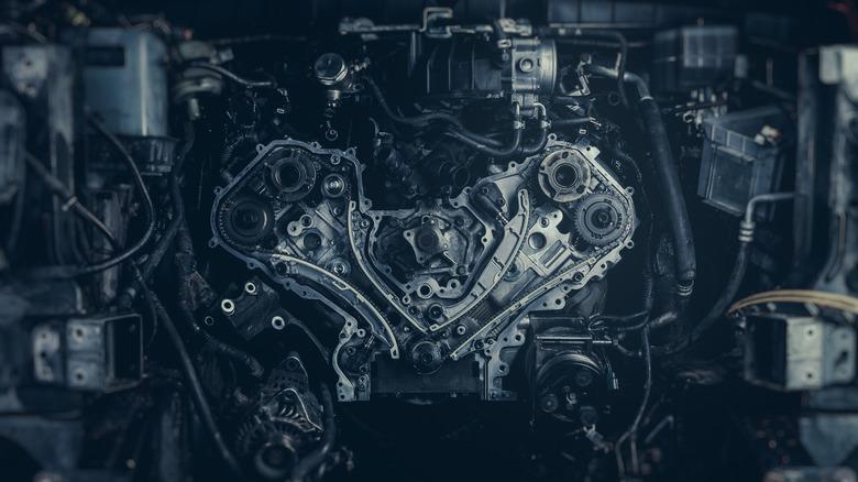Dual-overhead camshaft-equipped V8 engine with timing cover removed showing timing gears and chains