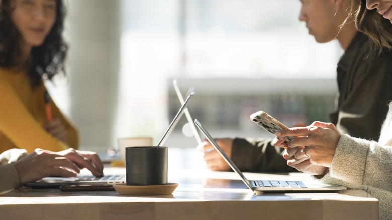 people using devices in public