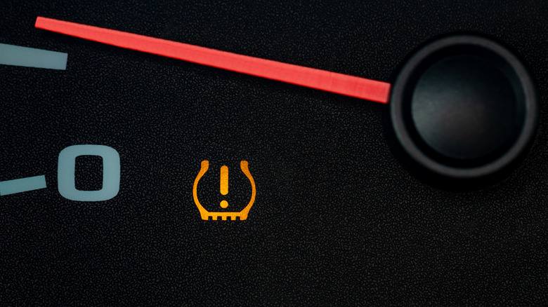 A low tire warning light on an unidentified car dashboard