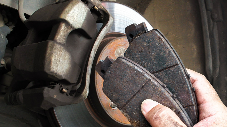 A mechanic replacing brake pads