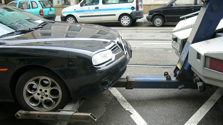 vehicle front wheels hitched on a tow truck