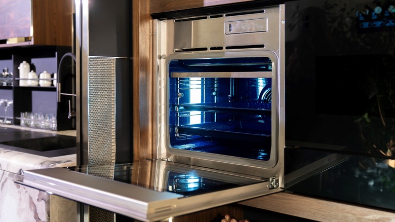Stainless steel wall oven in a kitchen with the lid open