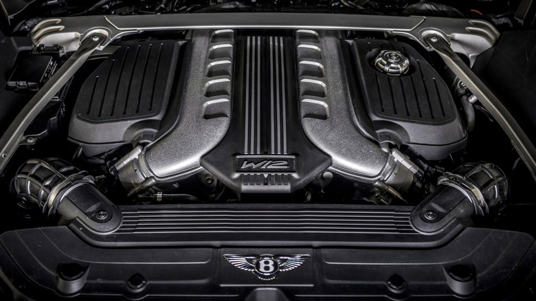 A Bentley W12 engine under a lifted hood.