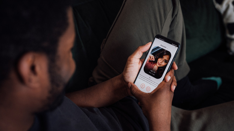 A person looking at a profile on their smartphone.