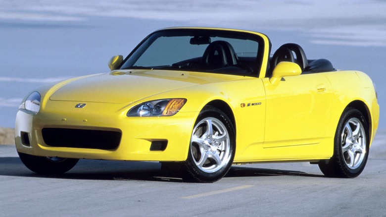 Yellow 2000 Honda S2000 parked on a road