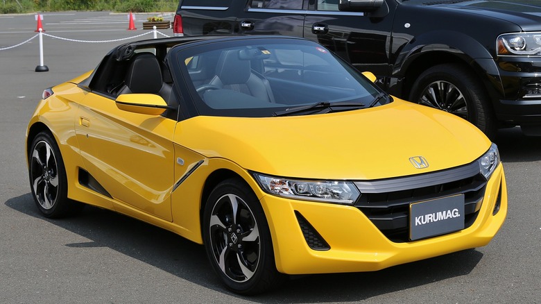 Yellow Honda S660 parked on asphalt