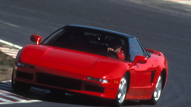First-generation Honda/Acura NSX driving on racetrack