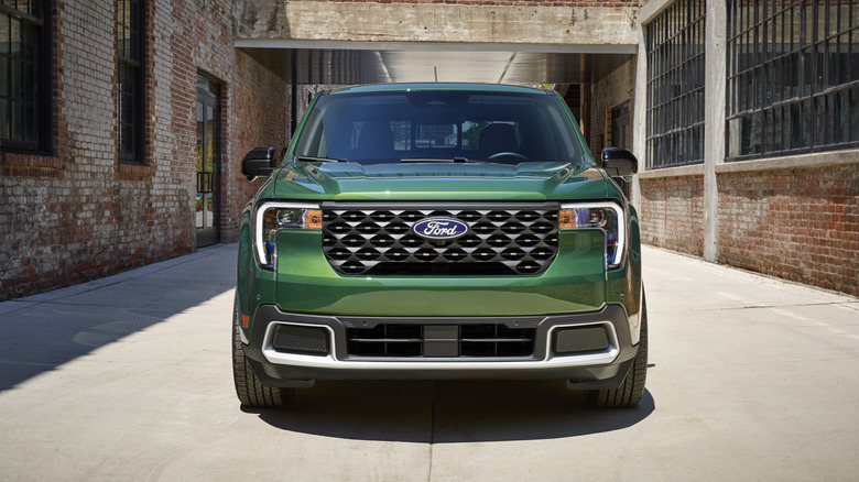 A green 2025 Ford Maverick in an alley.