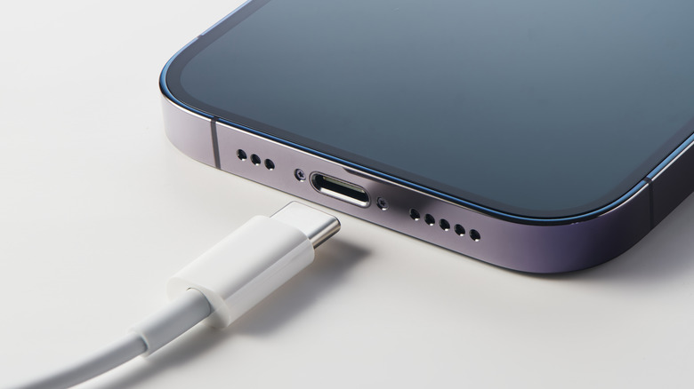 An Apple iPhone with a USB-C cable