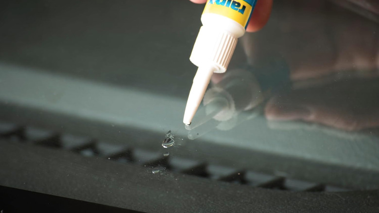 Person using Rain-X Windshield Repair liquid