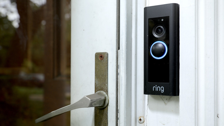 A Ring doorbell next to a closed door