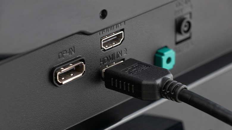 Multiple HDMI ports on the back of a TV with an HDMI cable plugged into it.